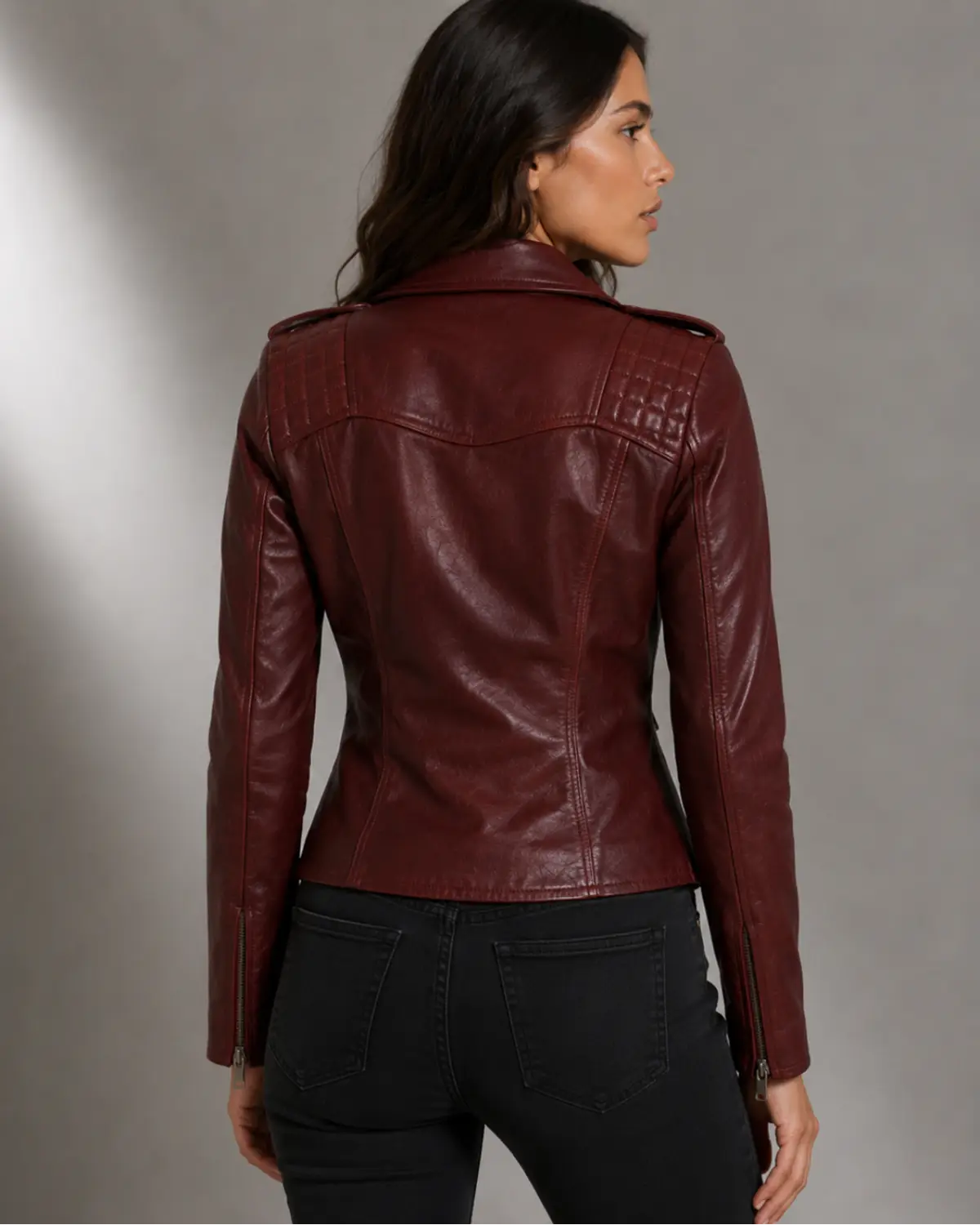 Woman wearing a burgundy Moto Biker Leather jacket with Silver zippers