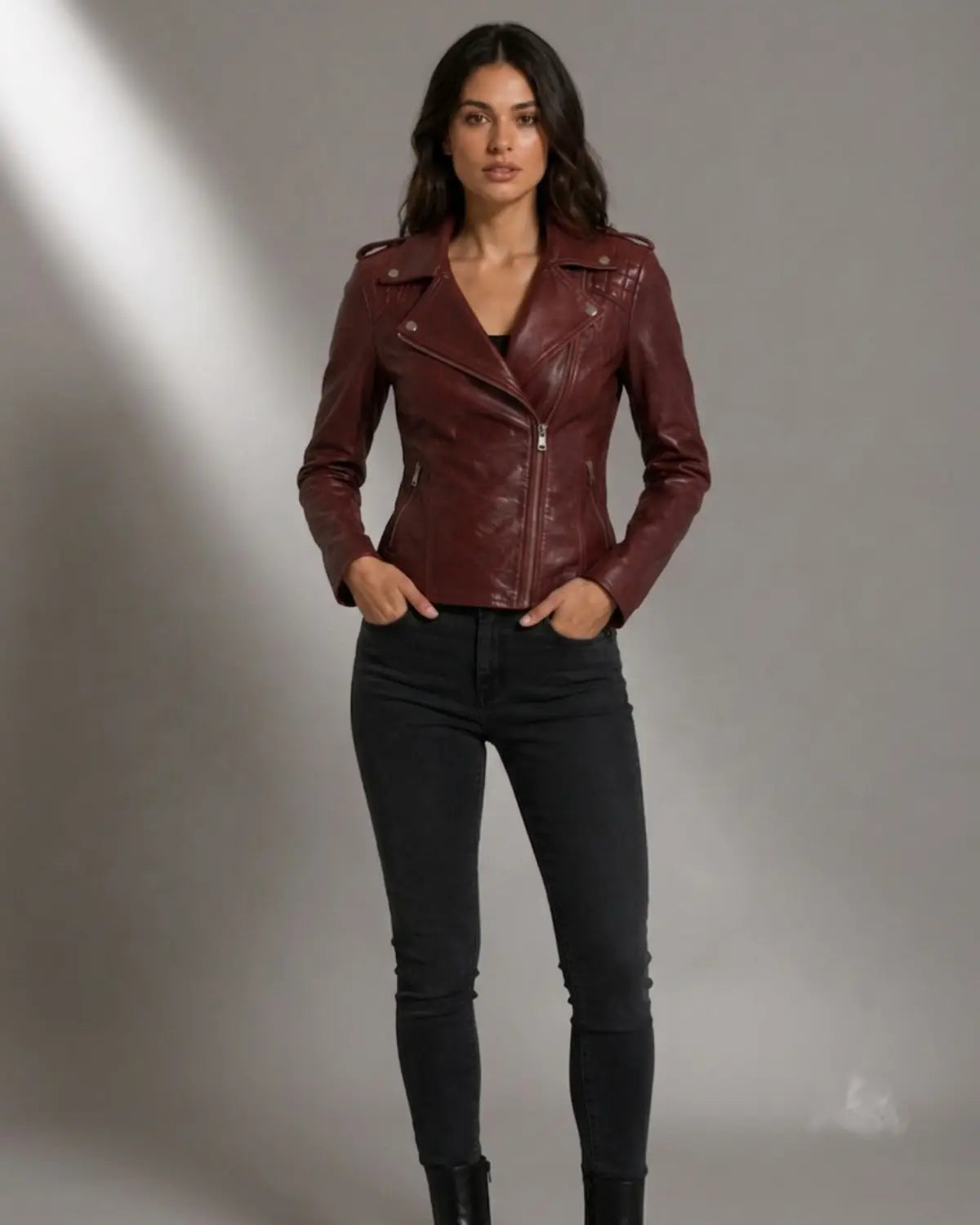 Woman wearing a burgundy Moto Biker Leather jacket with Silver zippers