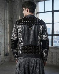 Person wearing a studded leather jacket in an urban setting