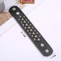 A black leather wristband or bracelet strap laid diagonally on a white surface, decorated with multiple silver metal spikes of varying sizes and three silver rivets. Black text on the image shows dimensions: 22.
