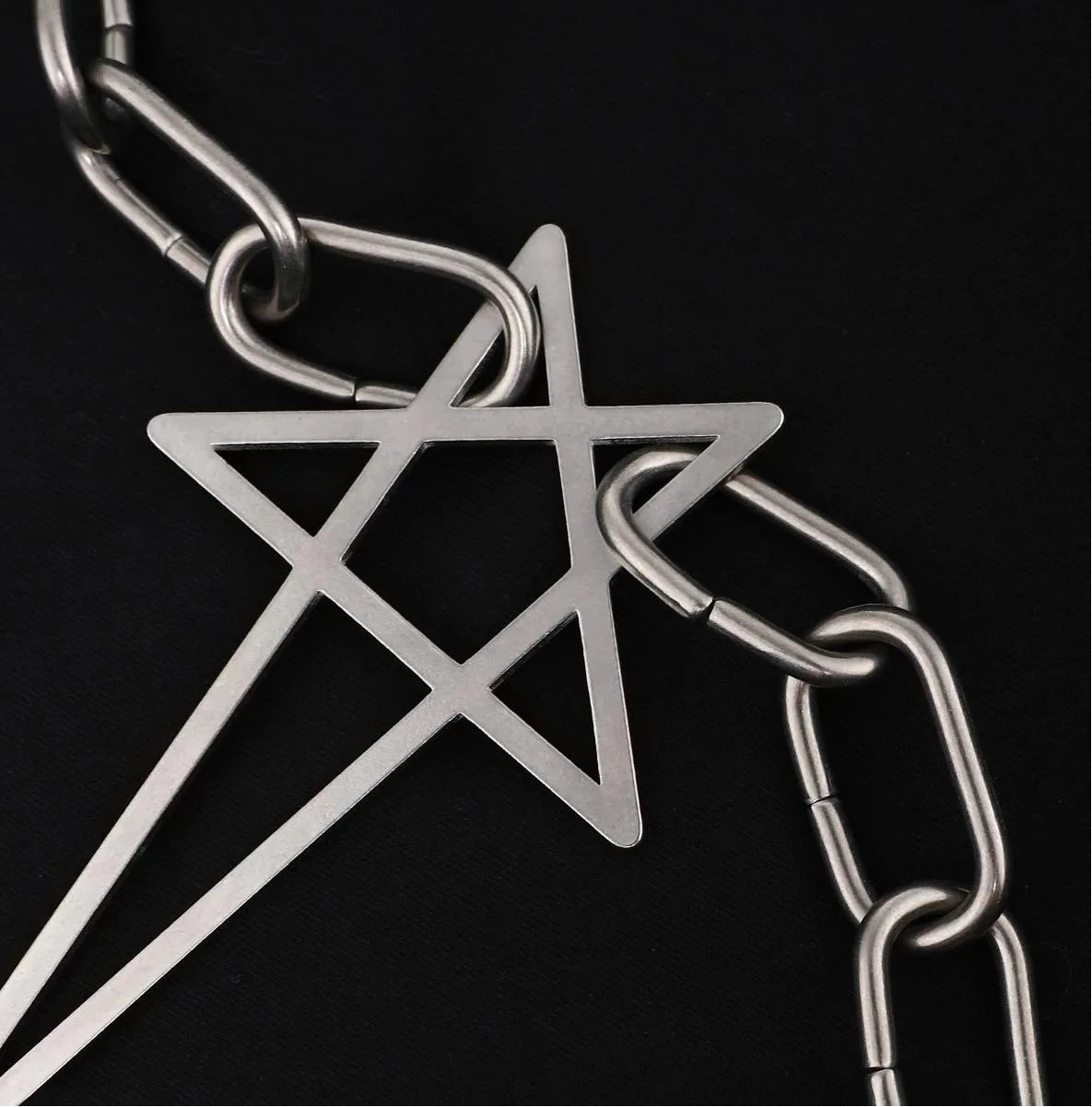 A close-up of a silver metal pentagram pendant linked with a chunky silver chain Star Inverted Pentagram Chain Statement Necklace with big star