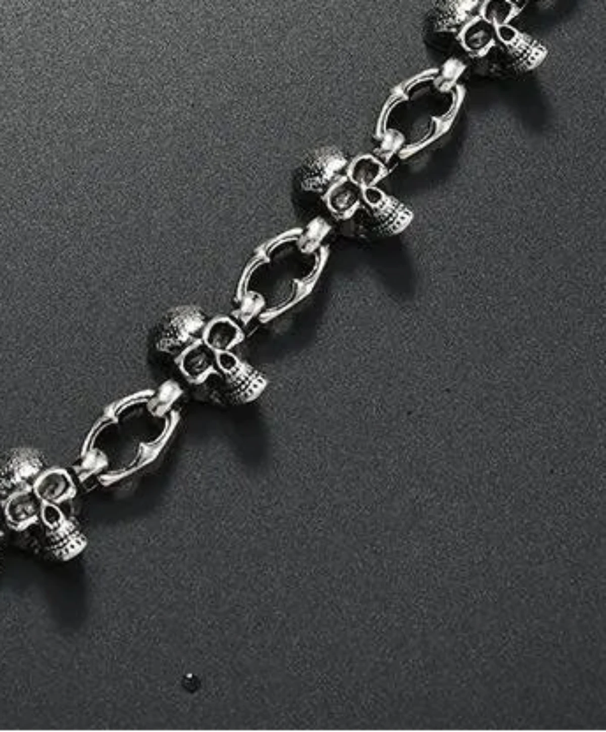 Silver chain with skull designs on a black background, Trouser chain for unisex, with Multi skull head worn mostly on loop of the jeans