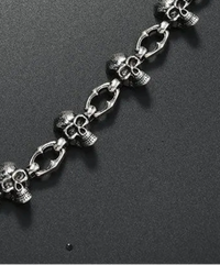 Silver chain with skull designs on a black background, Trouser chain for unisex, with Multi skull head worn mostly on loop of the jeans