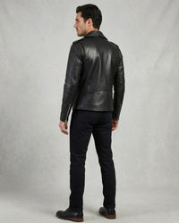 A man wearing a black leather biker jacket, black jeans,