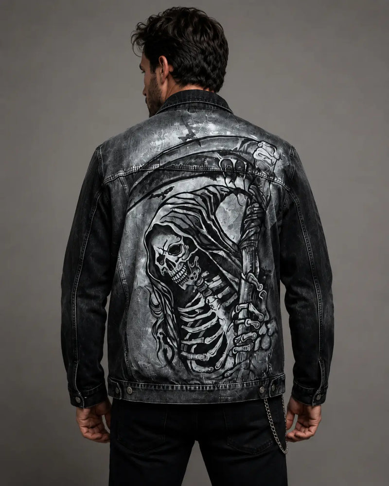 Hand-painted black acid wash denim jacket featuring a detailed grim reaper graphic on the back, shown on a male model