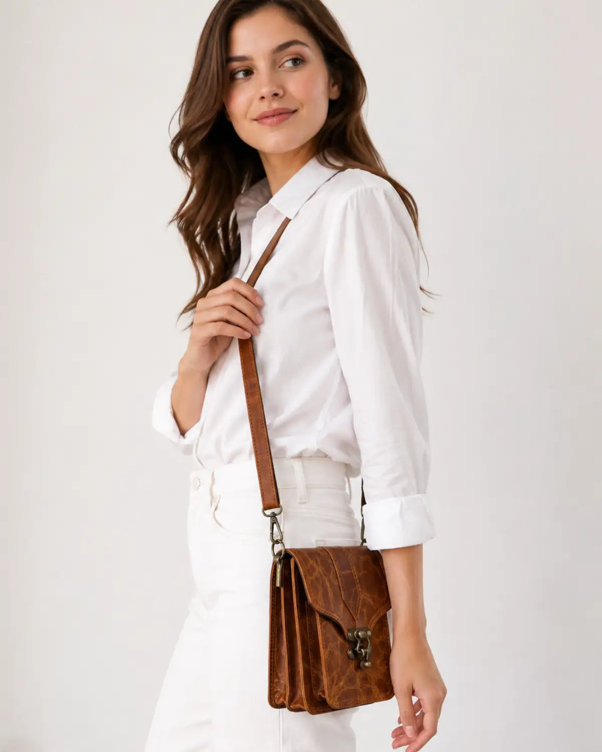 Brown crunch leather crossbody bag worn by female model