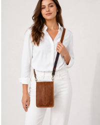 Brown crunch leather crossbody bag worn by female model